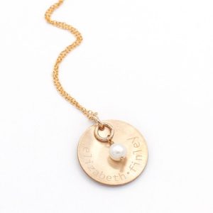 Engraved Gold Names And A Pearl Necklace